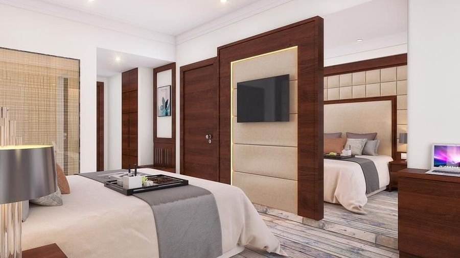 A cozy room with a king-size bed, wall-mounted television, and warm lighting at BluSalzz Residence, Amritsar.